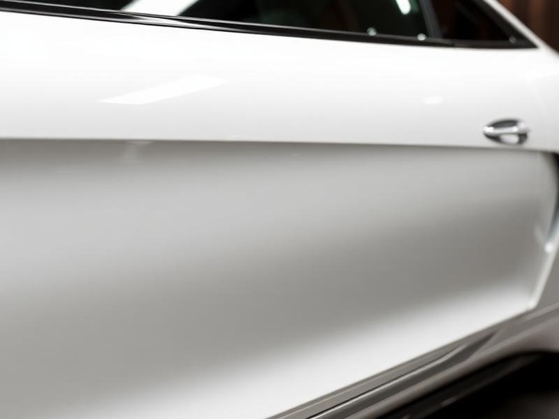 White car with perfect glossy finish after professional paint correction Scottsdale Arizona